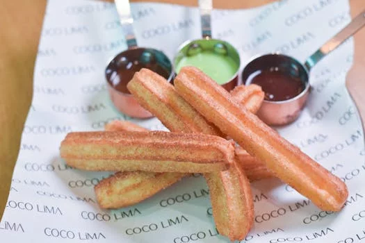 churros with chocolate sauce and tres leches cake
